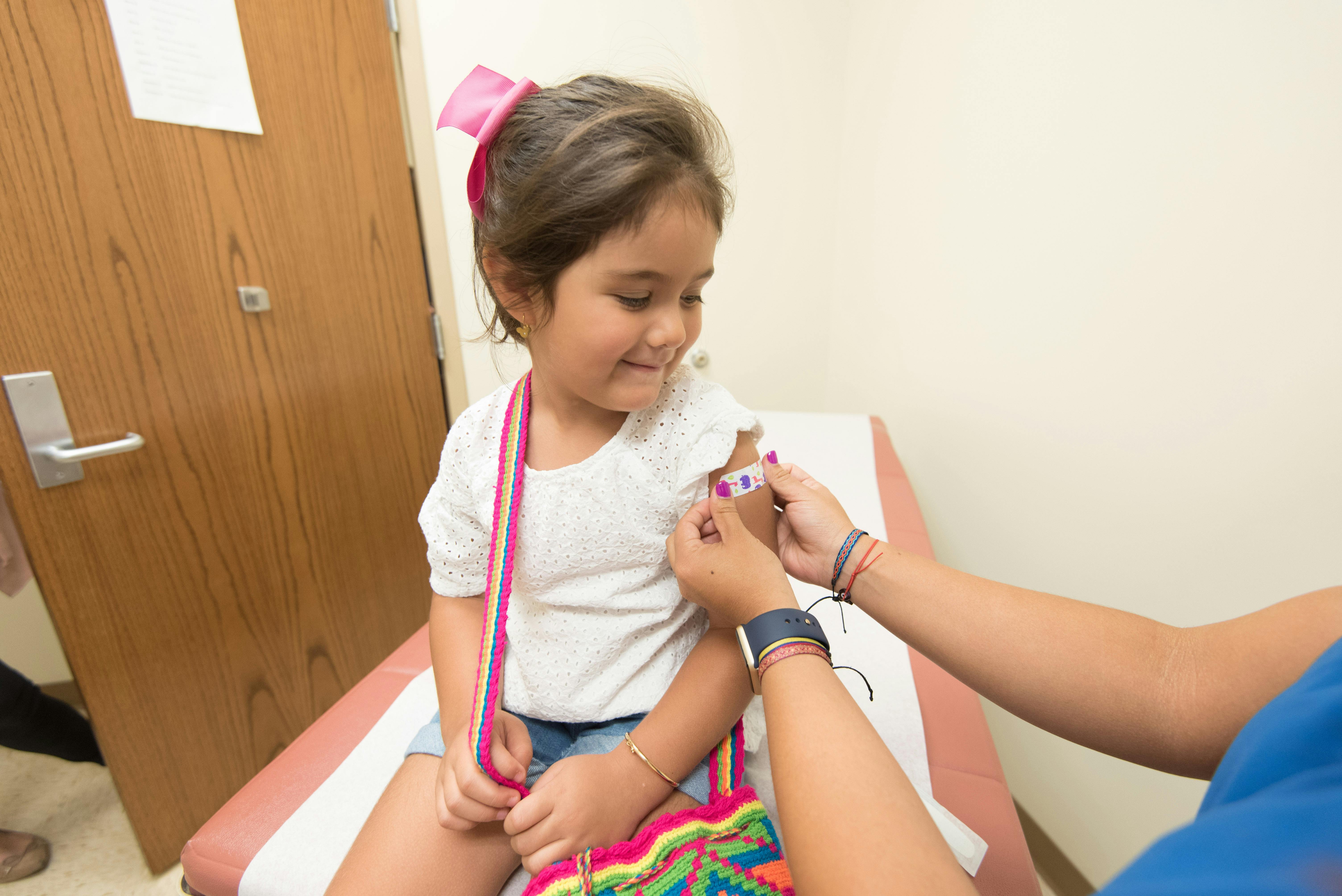 Pediatric healthcare provider examining child patient